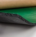 Krawędź arkusza maty StP Magma ukazująca wielowarstwową budowę materiału z zieloną warstwą butylu.