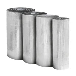 Trzy stojące rolki pianki kauczukowej powlekanej aluminium, stosowanej jako skuteczna paroizolacja.
