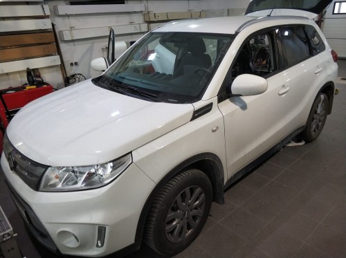 Białe Suzuki Vitara w warsztacie, przygotowane do kompleksowego wygłuszania całego wnętrza