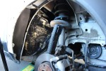 Zewnętrzne nadkole Dacii Lodgy z widocznym zawieszeniem w trakcie prac wygłuszeniowych