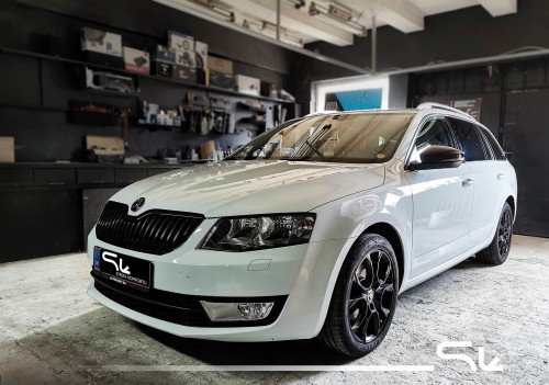 Biała Skoda Octavia III w warsztacie, przygotowana do kompleksowego wyciszenia drzwi, podłogi, dachu i nadkoli materiałami Bitmat